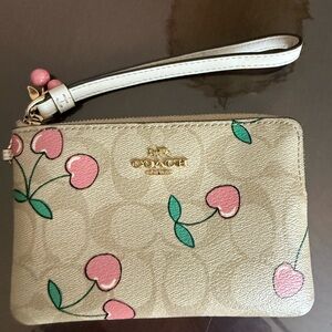 Coach Beige Wristlet with Pink Cherry Motif
Not sold anymore!